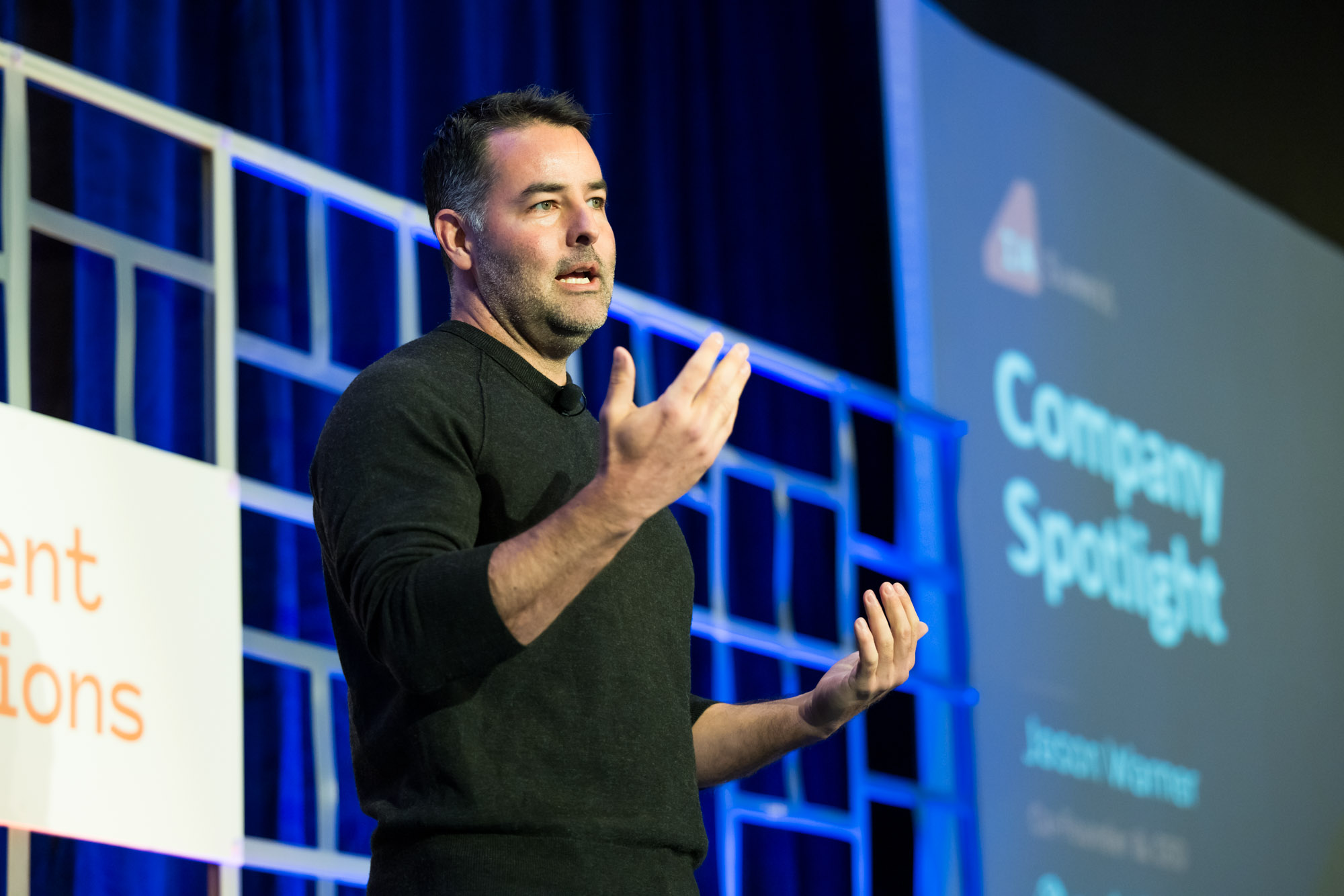 A speaker presents onstage at the 2023 Intelligent Applications Summit.
